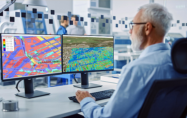 An engineer analyzing radio coverage maps on dual monitors, representing LS telcom’s approach to system design and radio planning for reliable communication networks. Click to learn more.