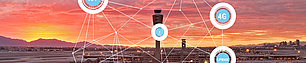 Airport Wireless Network Integration Panoramic view of an airport at sunset with the control tower centered. Overlaid network graphics connect various nodes with lines, featuring icons labeled '4G', 'LPWAN', and others, symbolizing wireless communication and network integration at the airport.